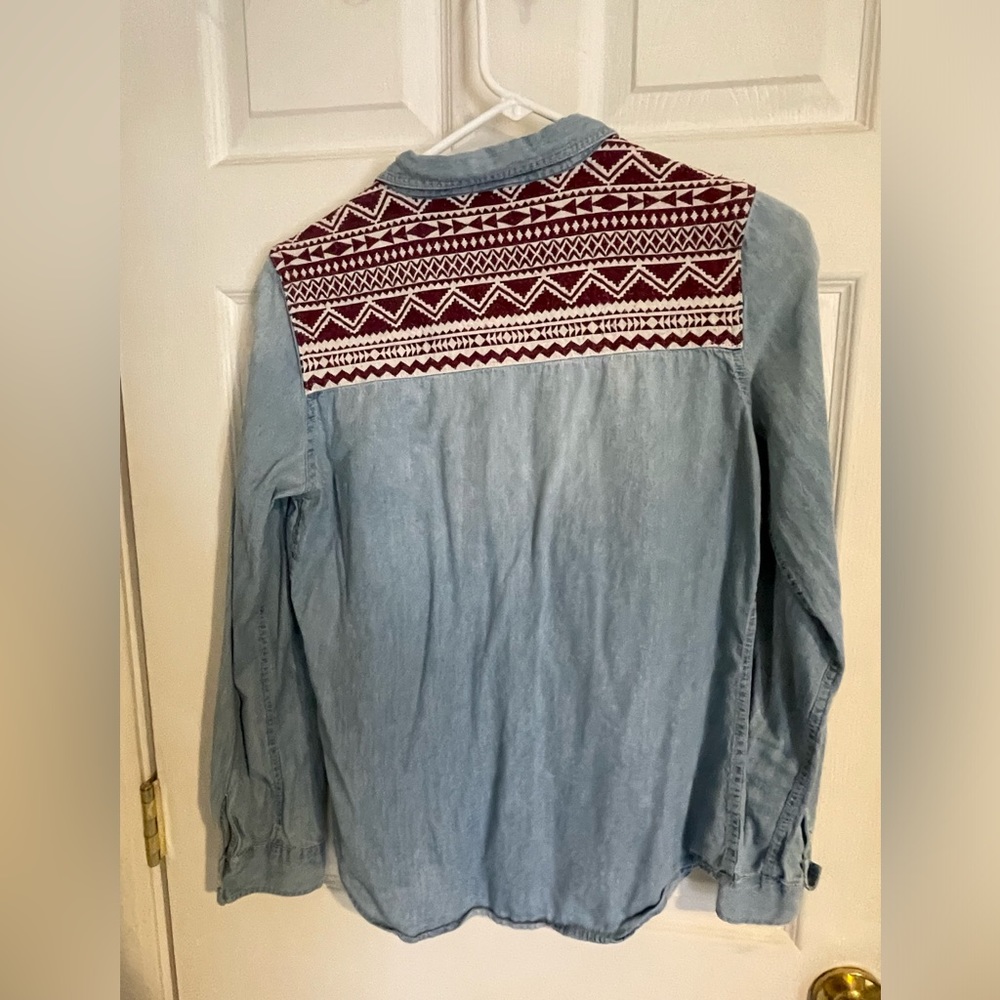 Super cute denim button up. The pattern on the shoulders/back.